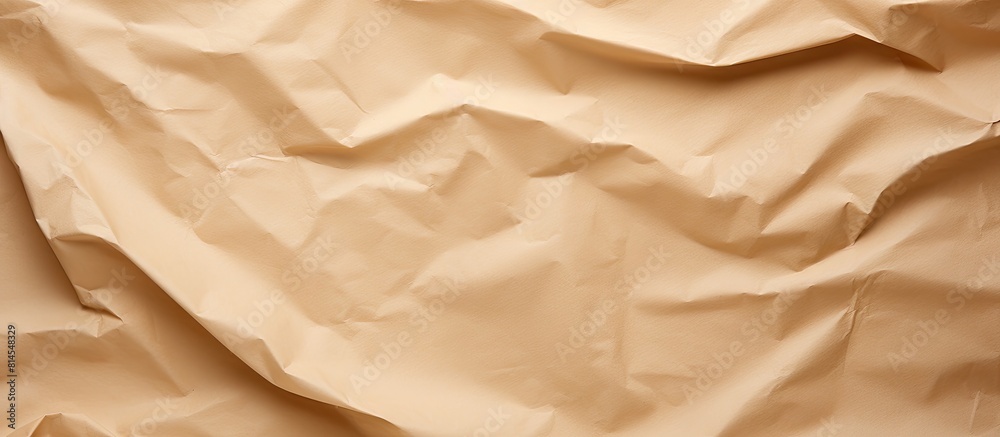 Poster a white sheet of crumpled paper contrasts against a brown paper background providing a clean area fo