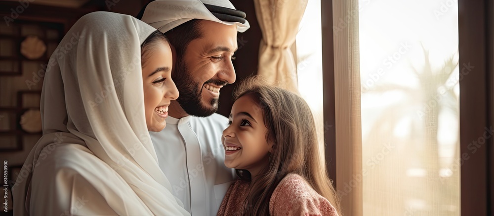 Poster Arabic parents happily pose with their young daughter in a homey setting The portrait captures their joyful bond in a comfortable environment. with copy space image. Place for adding text or design