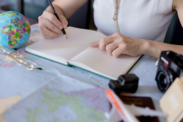 Woman traveler planning vacation trip  by searching the route on the map, Travel concept.