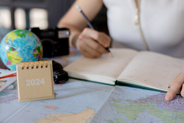 Woman traveler planning vacation trip  by searching the route on the map, Travel concept.