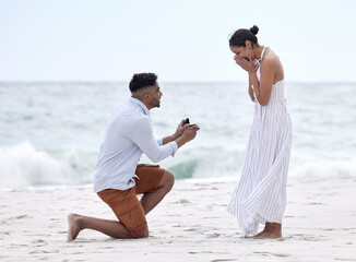Couple, proposal and ring at beach on vacation, holiday and destination for marriage as boyfriend...