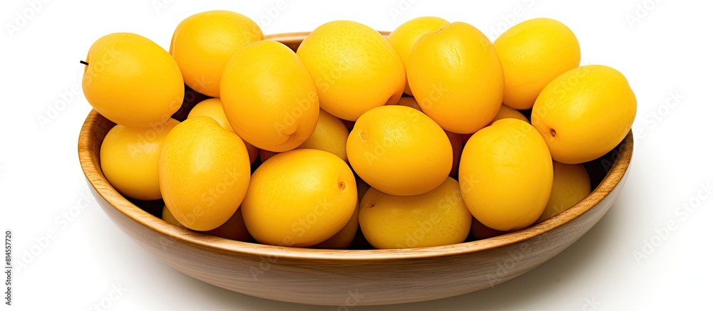 Poster Top view of yellow plums arranged in a wooden bowl on a white background creating a visually appealing copy space image that appeals to those interested in vegetarian or healthy eating