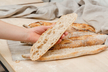 Homemade Italian ciabatta bread cut on the table