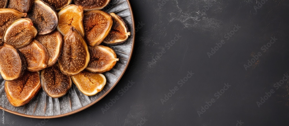 Poster Top view of a plate of dried figs on a grey background with ample space for text creating a copy space image The figs exude healthiness and nutrition