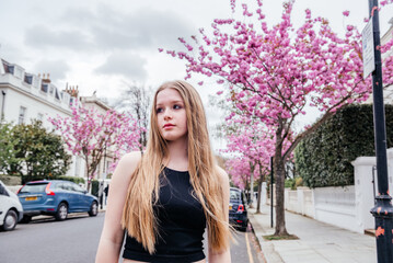 Young Blonde Girl and Blossoming Cherry Trees in London