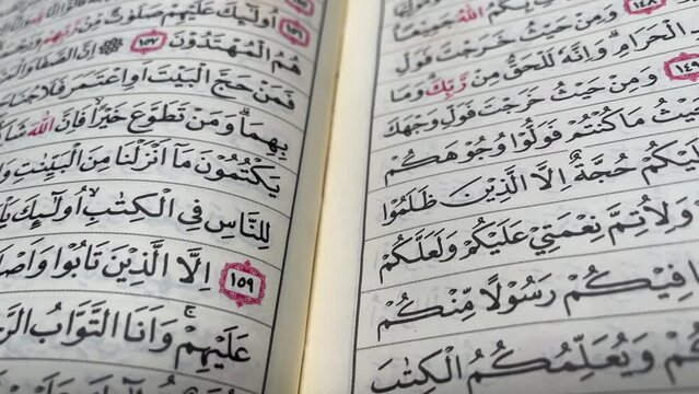  B roll clip opens a page of the Koran. Al-Quran pages with Arabic calligraphy