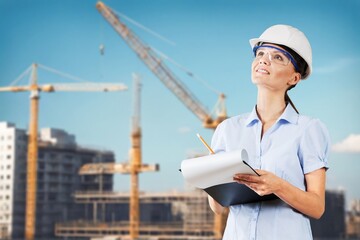 business person with a clipboard at construction site