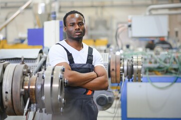 An African-American male worker in a plastic window frame factory