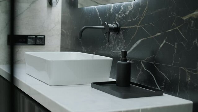 Modern Bathroom Detail with Marble Backsplash and Designer Sink