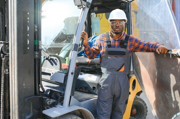 African American Man at work. Professional operation engineering. Young worker forklift driver