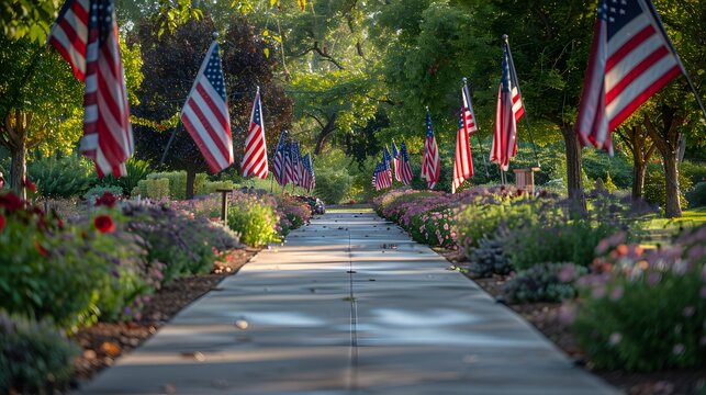 A row of American flags lines the pathway leading to a solemn memorial, honoring the sacrifices of fallen heroes with dignity and respect.