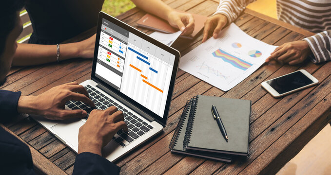 Project planning software for modish business project management on the computer screen showing timeline chart of the team project