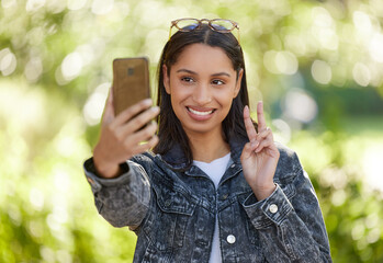 Young woman, selfie and smile outdoor in park for social media, internet sharing and memories. Happy, female person or student in nature with technology for communication, contact and online post