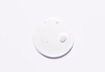 round drop of transparent gel serum on a light background