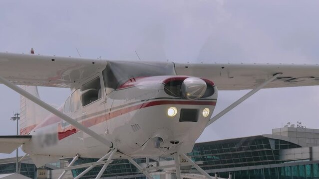 Floatplane, seaplane - light utility aircraft with floats and spinning propeller at the airshow, exhibition at the airport of Istanbul, Turkey: close up. Transportation, journey and tourism concept