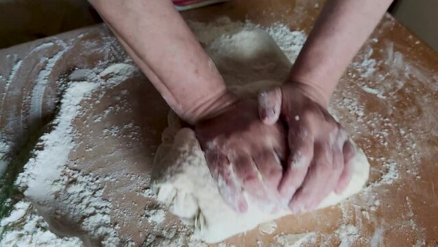 Woman hands kneading dough. Close Up shot of hands of bakery chef kneading dough