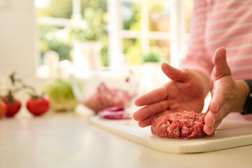 Close Up Of Woman At Home Preparing Meal In Kitchen Shaping Beef Patty Or Burger