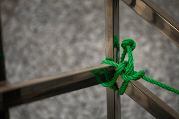 Nylon rope knot on a steel pole.