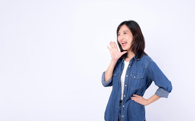 Asian woman wearing denim jean is posing with a shouting gesture against a white background.