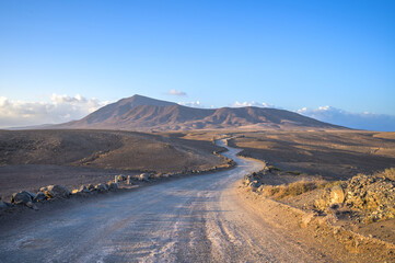 Empty desert road at the sunset with copy space. Papagayo beach, Lanzarote, Canary Island