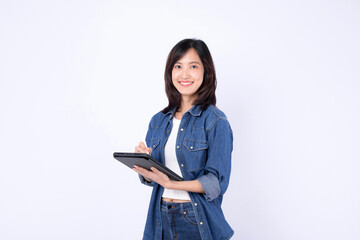 Asian woman wearing denim jean is holding a tablet and a stylus against a white background.