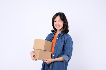 young asian woman wearing orange t-shirt and denim shirt holding parcel box isolated on white studio background, Delivery courier and shipping service concept.