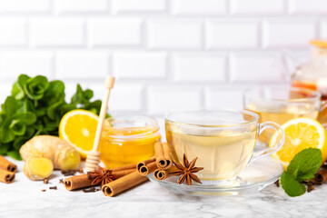 Fragrant hot tea with cinnamon stick and anise on a textured wooden background. A cup of hot tea...