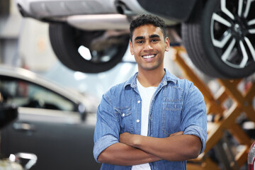 Portrait, man and smile as mechanic or engineer in automobile, workshop and repairs with confident...