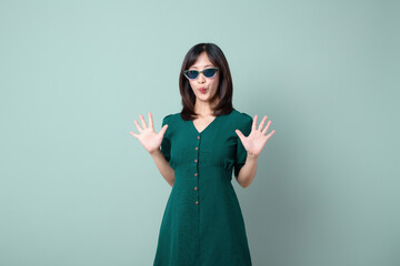 Asian woman green dress celebrated isolated on green background.