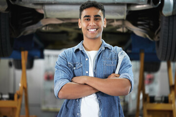 Portrait, man and smile as mechanic in automobile, workshop and repairs with confident or pride as...