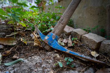 A pickaxe, or pick is a generally T-shaped hand tool used for prying. Garden tools in an organic...