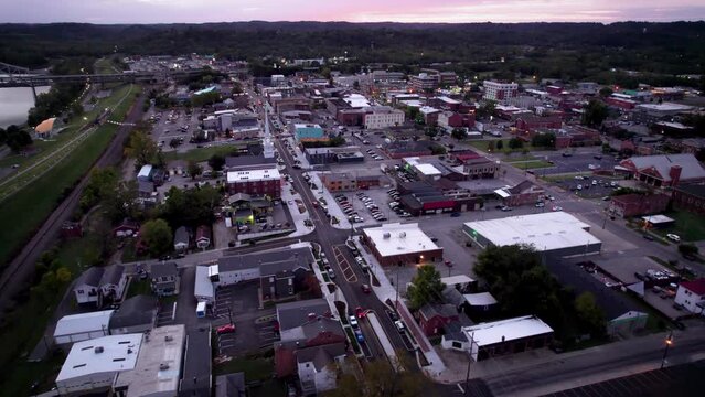 Drone footage of New Albany cityscape and Sherman Minton Bridge over Ohio River at sunset, USA