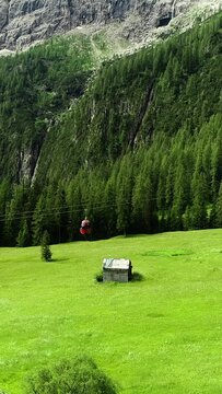 Aerial tramway lift in Italian Alpine landscapes, vertical video.