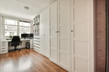 Modern home office with large white closet and desk setup