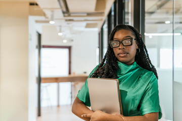 Professional woman with laptop in modern coworking space