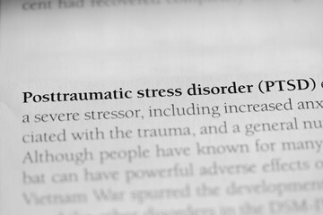 Close-up of the term Posttraumatic Stress Disorder (PTSD) printed in black on white paper