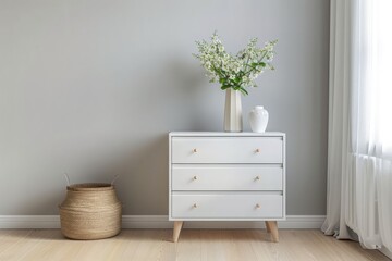White modern dresser minimalistic furniture in empty room on grey wall background, small cupboard with decor, vases and lily of the valley flowers bouquet, cozy apartment house interior concept