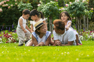 Asian family enjoying a vacation in a European garden