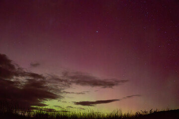 Red and yellow sky glow of Aurora Australis over Matakaea (Shag Point) in the South Island of New Zealand during the widely seen aurora of May 2024.