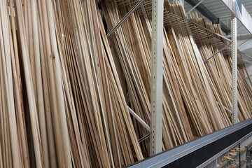 Shelf of a building materials store with wooden slats standing on it. Close up.