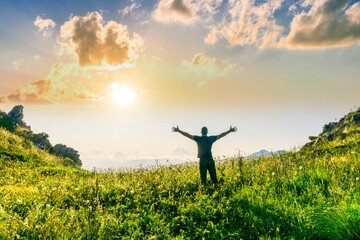 happy man watching amazing highland evening sunset, person delight with nature landscape