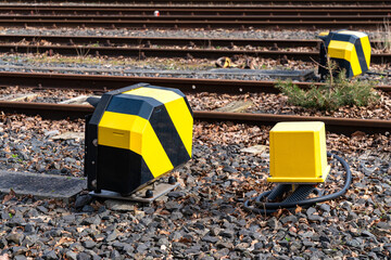 Black and yellow controller switch boxes for railway switches. Multiple railway.