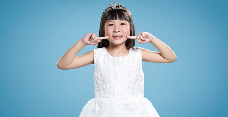 Little princess in white dress smiling