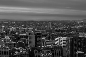 a black and white view of city buildings in a city