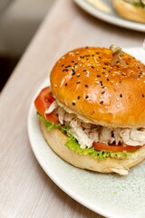 there is a large sandwich on the plate with other foods
