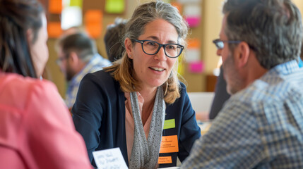 Small groups of professionals gather around conference tables, exchanging ideas and feedback with confidence and respect for one another