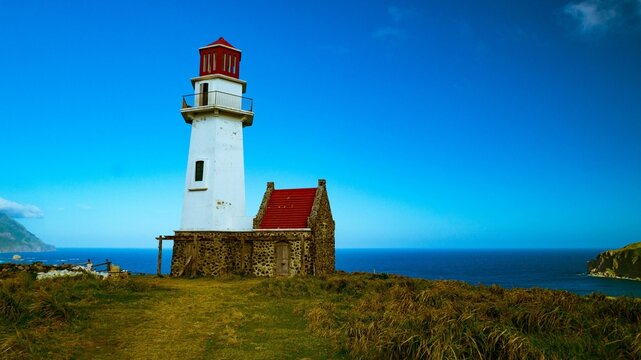 Scenic view of a lighthouse perched atop a hill in Batanes, Philippines