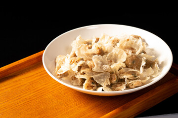 a bowl of food on a wooden table and a book