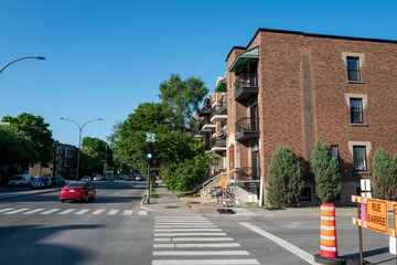 two signs sitting at the side of a street next to cars