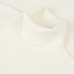 Creamy white wool turtleneck sweater close up